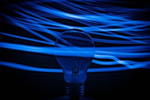 Picture showing a lightbulb with blue electrical waves running through it